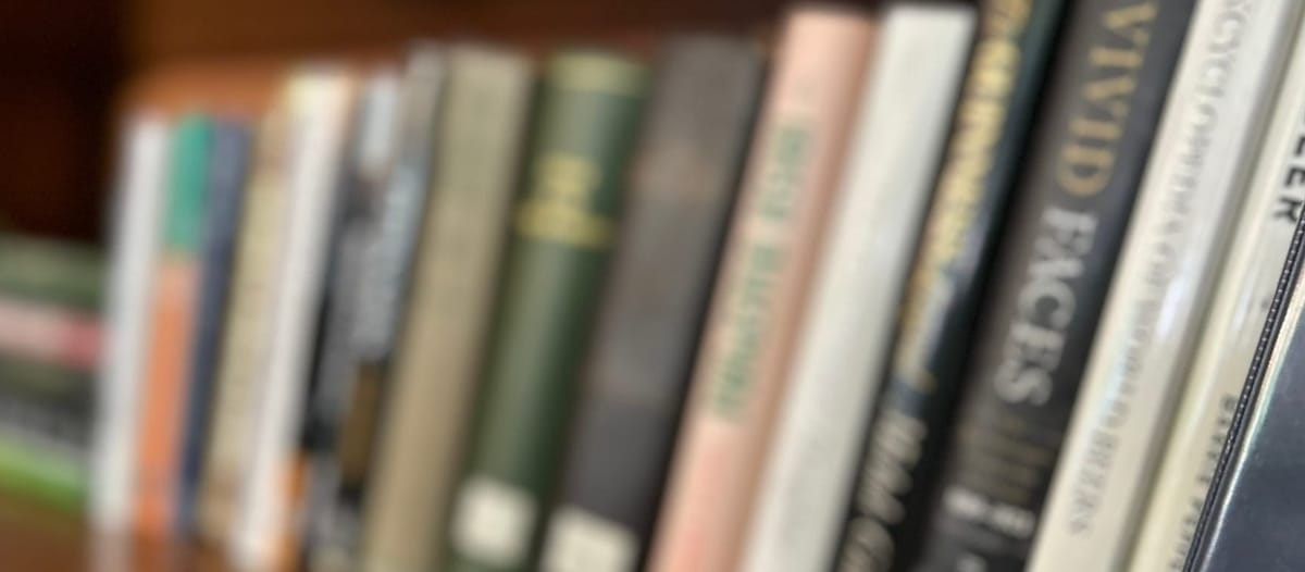 Dozens of books alinged on a shelf, slightly blurred but unmistakeably about Ireland and Guinness